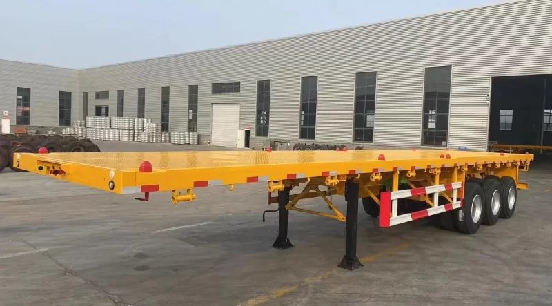 ⁦Best selling factory direct sale 3/4 axles heavy duty flatbed Semi Trailer 20FT 40FT Flat Bed Container truck trailers⁩ - الصورة ⁦2⁩