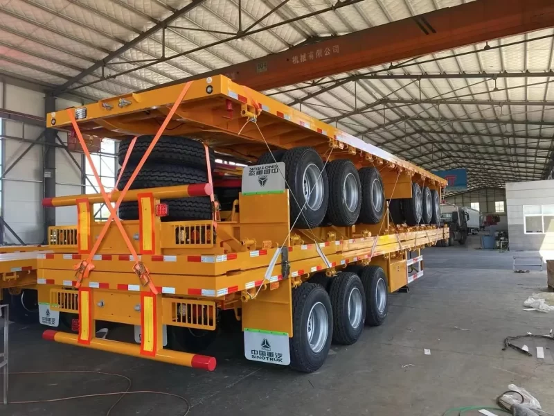 ⁦Best selling factory direct sale 3/4 axles heavy duty flatbed Semi Trailer 20FT 40FT Flat Bed Container truck trailers⁩ - الصورة ⁦4⁩